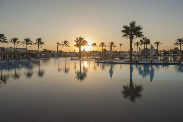 Stor pool i en lyxiga tropiska hotellanläggning vid soluppgången — Stockfoto