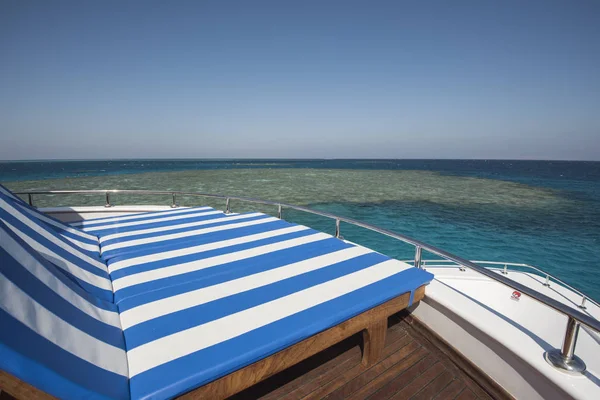 Sun loungers on the bow of a large luxury motor yacht — Stock Photo, Image