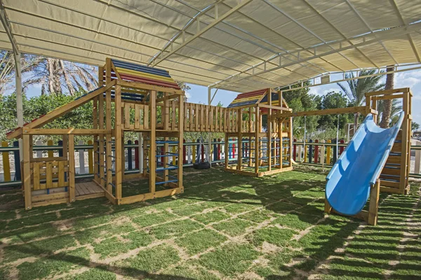 Large wooden climbing frame in children's playground area — 图库照片