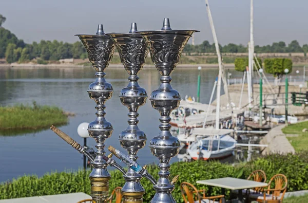 Traditional Egyptian shisha pipes with boats on the river Nile — Stock Photo, Image