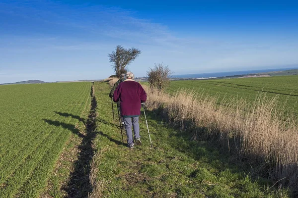 Two Elderly People Walking Ramblers Remote Country Lane Footpath Hill — Stock Photo, Image