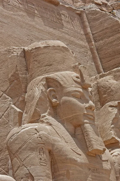 Exterior of ancient egyptian temple of Ramses II in Abu Simbel with closeup of giant statues and hieroglyphics