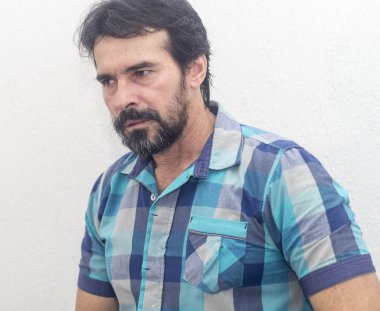 Bir beyazın Siyah sakallı, birkaç gri saç, mavi ekose gömlek giyer, bir şey ilginç, farklı pozisyonlarda ellerini jestlerle bakar.