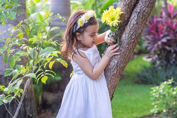 A girl in white dress on stone in the forest — Stock Photo, Image