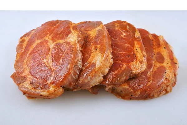 Meat, Pork neck in marinade and on a chopping boardon, on a white background Royalty Free Stock Photos