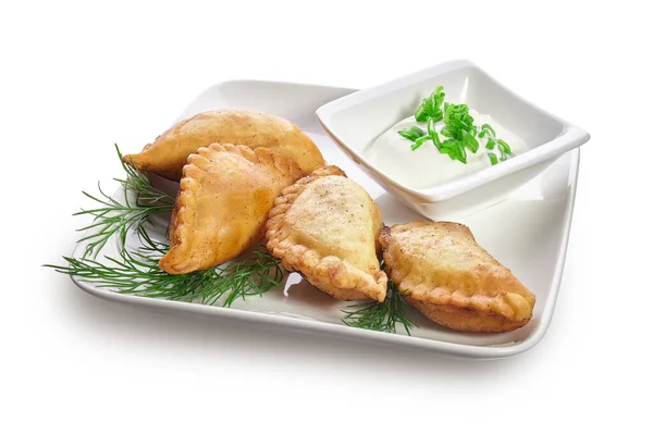 Chebureks on a white plate isolated on a white background Royalty Free Stock Photos