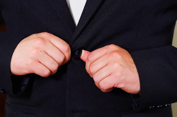 Closeup mans chest area wearing formal suit and tie, adjusting jacket buttons using hands, men getting dressed concept — Stock Photo, Image