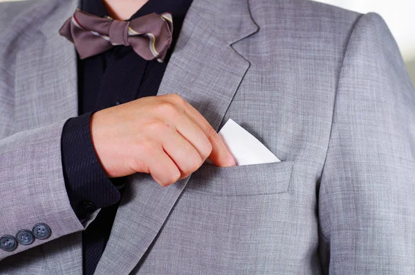 Closeup mans chest area wearing formal suit and tie, placing tissue in jacket pocket, men getting dressed concept — Stock Photo, Image