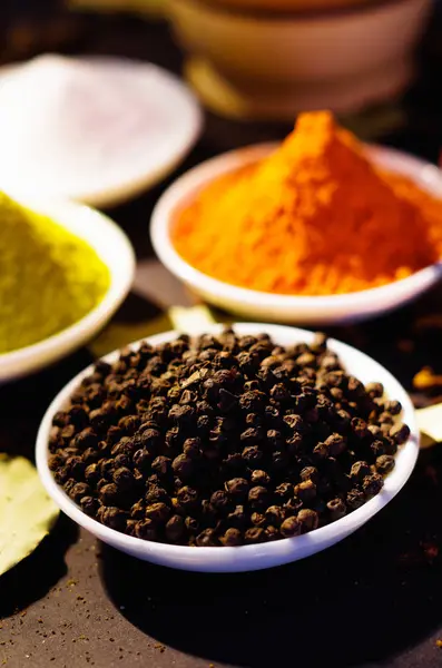 White bowls spread out with different colorful spices inside, beautiful rustic setting, spice and herbal concept — Stock Photo, Image