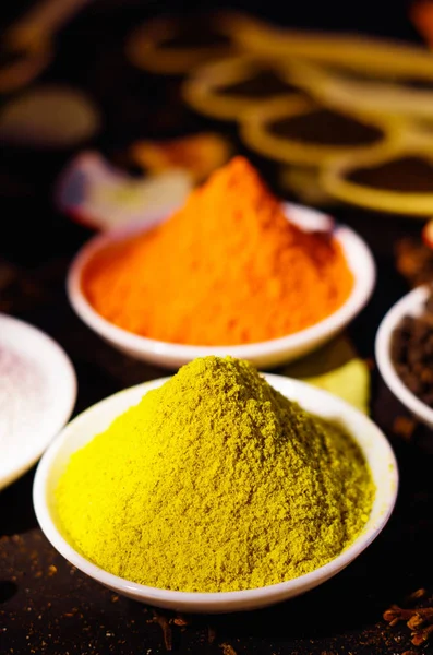 White bowls spread out with different colorful spices inside, beautiful rustic setting, spice and herbal concept — Stock Photo, Image