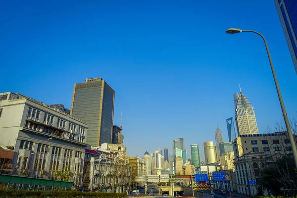 SHANGHAI, CHINA: Some tall modern buildings making up the horizon, walking on the streets of Shanghai — Stock Photo, Image