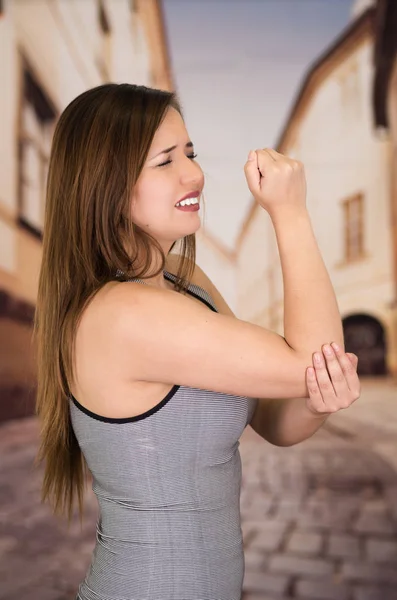 Beautiful young woman with elbow pain — Stock Photo, Image
