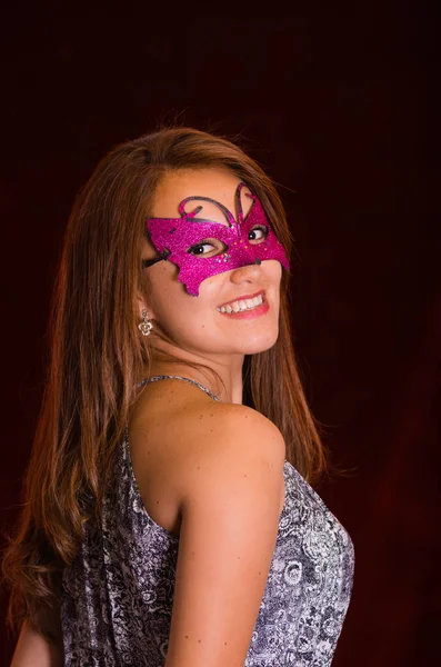 Beautiful model woman wearing pink carnival mask — Stock Photo, Image