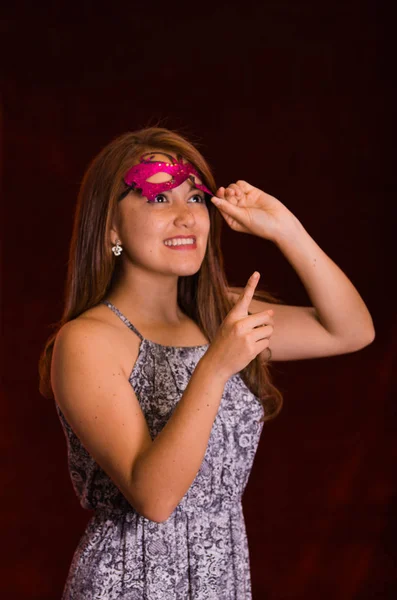 Beautiful model woman wearing pink carnival mask — Stock Photo, Image