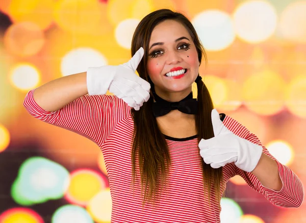 Closeup portret van schattig jong meisje clown MIME-bedrijf in duimen — Stockfoto