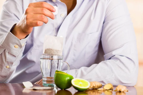 Man preparing a deleighful cup of tea with ginger and lemon home antimicrobial therapy — Stock Photo, Image