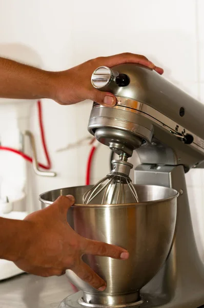 Bread Mixer In Bakery, mixing dough for baguettes in a bakery machine for mixing dough, a man is using his both hands to manipulate the machine — Stock Photo, Image