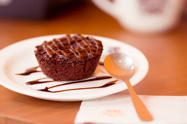 美味的巧克力蛋糕，在板仿古木制的桌子上用勺子在板 — 图库照片