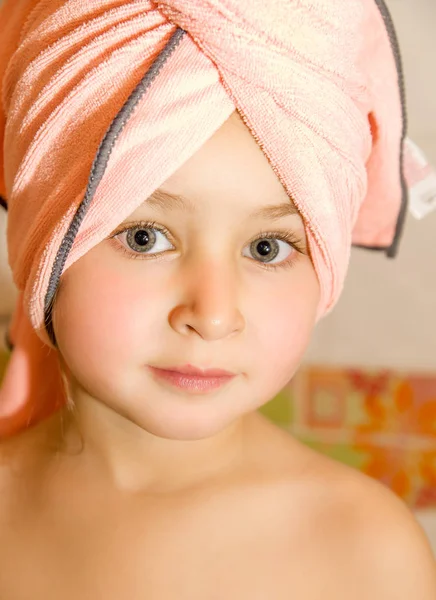 Little beautiful girl with a bright eyes with a pink towel in her head — Stock Photo, Image