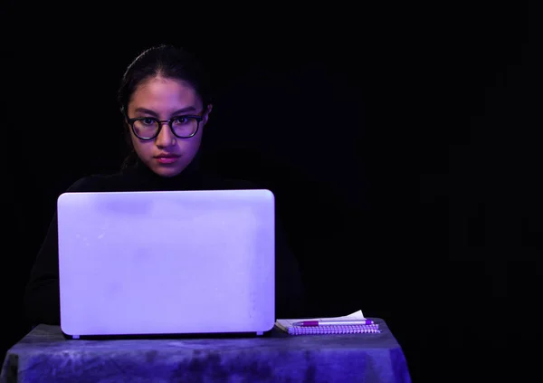 Portrait of hacker with laptop on dark background — Stock Photo, Image