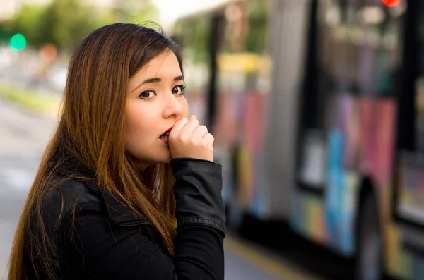 防护口罩咳嗽在空气污染，背景模糊的公共交通工具的城市街道上一名年轻女子的特写 — 图库照片
