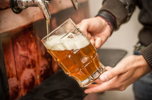 Barman enchendo-se com uma cerveja artesanal loira em um copo de cerveja — Fotografia de Stock