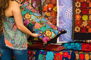 Dışarıda, and geleneksel kıyafetleri, renkli kumaşlar arka plan renkli çiçekli yastık onun elinde tutan genç bir kadının yakın çekim