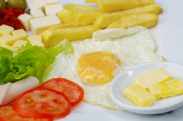 Close up of a delicious fresh mediterranean luch with egg, lettuce, ham tomato, cheesse, fried potato and somes olives on a wooden table — Stock Photo, Image