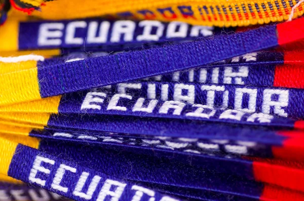 OTAVALO, ECUADOR - MAY 17, 2017: Beautiful andean bracalets with the color of the ecuadorian flag including the name of ecuador in the blue part, andean textile yarn and woven by hand in wool — Stock Photo, Image