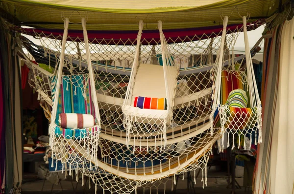 OTAVALO, ECUADOR - MAY 17, 2017: Andean traditional hammock textile yarn and woven by hand in wool, colorful fabrics background — Stock Photo, Image