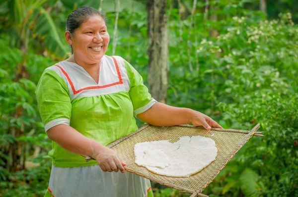 Lago Agrio, Ecuador - 17 November 2016: Kvinna visar matlagning yucca tortillas i ett utekök i en Siona by i Cuyabeno Wildlife Reserve, Ecuador — Stockfoto