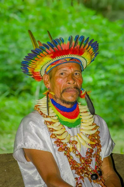 LAGO AGRIO, ECUADOR - 17 DE NOVIEMBRE DE 2016: Acercamiento de un chamán de Siona en traje tradicional con sombrero de plumas en un pueblo indígena de la Reserva de Vida Silvestre Cuyabeno — Foto de Stock