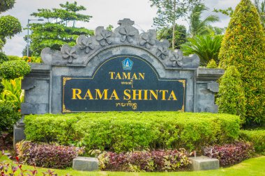 BALI, INDONESIA - MARCH 08, 2017: Informative sign on stone abot telajakan jalan dan taman rama sinta statue in terminal mengwitani, located in Denpasar in Indonesia