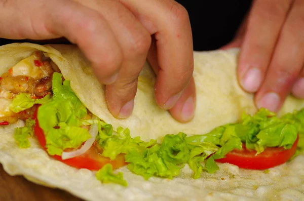 Delicious shawarma being wrapped, inside with meat and vegetables inside — Stock Photo, Image