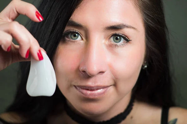 Mooie jonge vrouw houden van een open witte neus masker om de huid schoon — Stockfoto