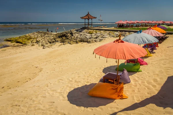 Beautiful sunny day with colorful umbrellas in a row in the beach of Pantai pandawa, in Bali island, Indonesia — Stock Photo, Image