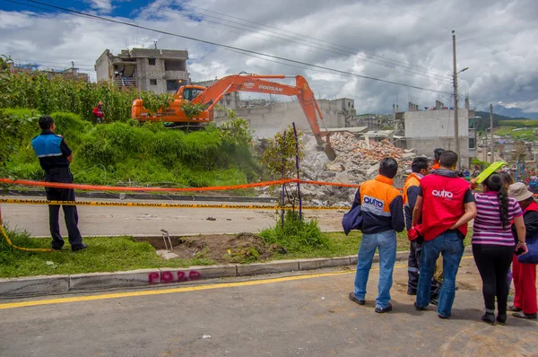 Quito, Ekvator - Nisan, 17, 2016: Tanımlanamayan bir grup insan deprem ve ağır makine Quito, Ekvator içinde felaket Temizleme tarafından yok ev arıyorum
