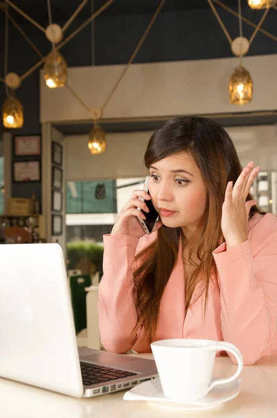 Primer plano de una joven empresaria estresada en la oficina mientras usa un teléfono celular. Concepto empresarial — Foto de Stock