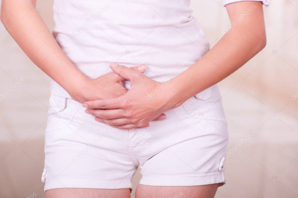 Young woman touching her belly, suffering menstrual period pain, female health concept