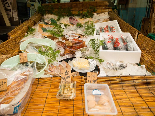 OSAKA, JAPÓN - 18 DE JULIO DE 2017: Mariscos dentro de cajas de plástico, en un mercado en el mercado de Kuromon Ichiba en Osaka, Japón. es un mercado muy popular en Osaka — Foto de Stock