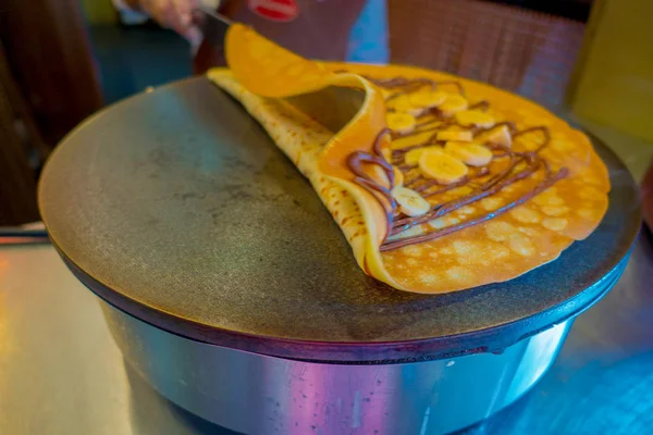 Making banana chocolate Pancake on an electric cooker — Stock Photo, Image