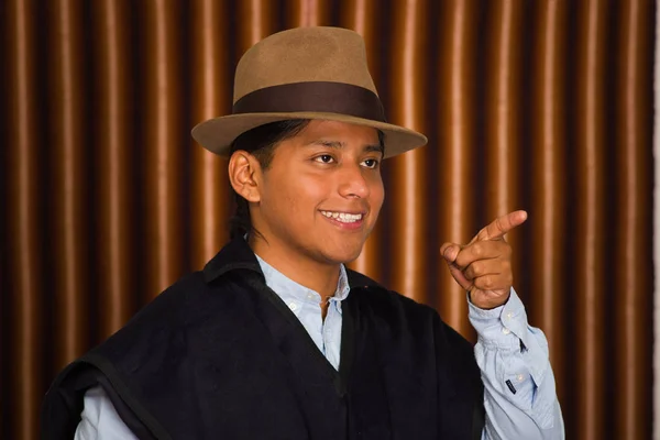 Portrait of indigenous young man wearing traditional hat and poncho from Otavalo, Ecuador — Stock Photo, Image