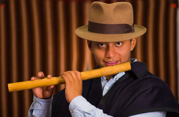 Close up portrait of indigenous young man playing the quena flute — Stock Photo, Image