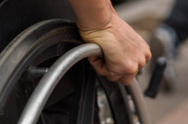 tekerlekli sandalye parkta yürüyüş sırasında tekerlek üzerinde erkek eli yakın çekim
