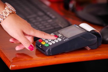 Yeni teknoloji ile modern ödeme akıllı bir saat kullanarak ve bazı düğmelere basarak satın almak ve satmak ürünler hizmet ahşap bir masa üzerinde