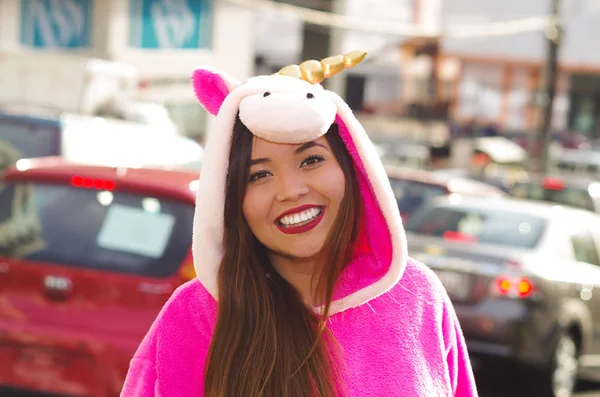 Portrait of a beautiful smiling young woman wearing an unicorn costume, at outdoors in the city of Quito — Stock Photo, Image