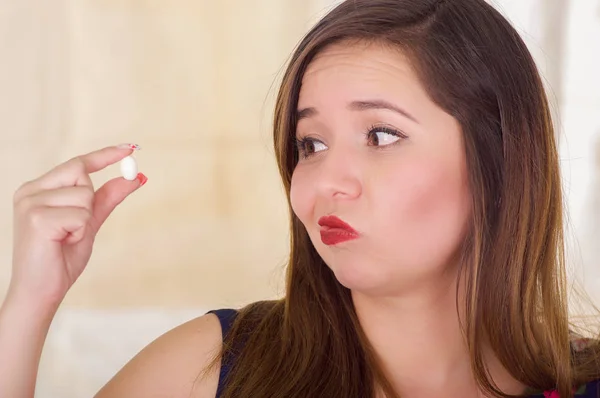 Portrait of a young woman holding in her hand a soft gelatin vaginal tablet or suppository, treatment of diseases of the reproductive organs of women and prevention of womens health — Stock Image Portrait of a young woman holding in her hand a soft gelatin vaginal tablet or suppository, treatment of diseases of the reproductive organs of women and prevention of womens health Stock Photo