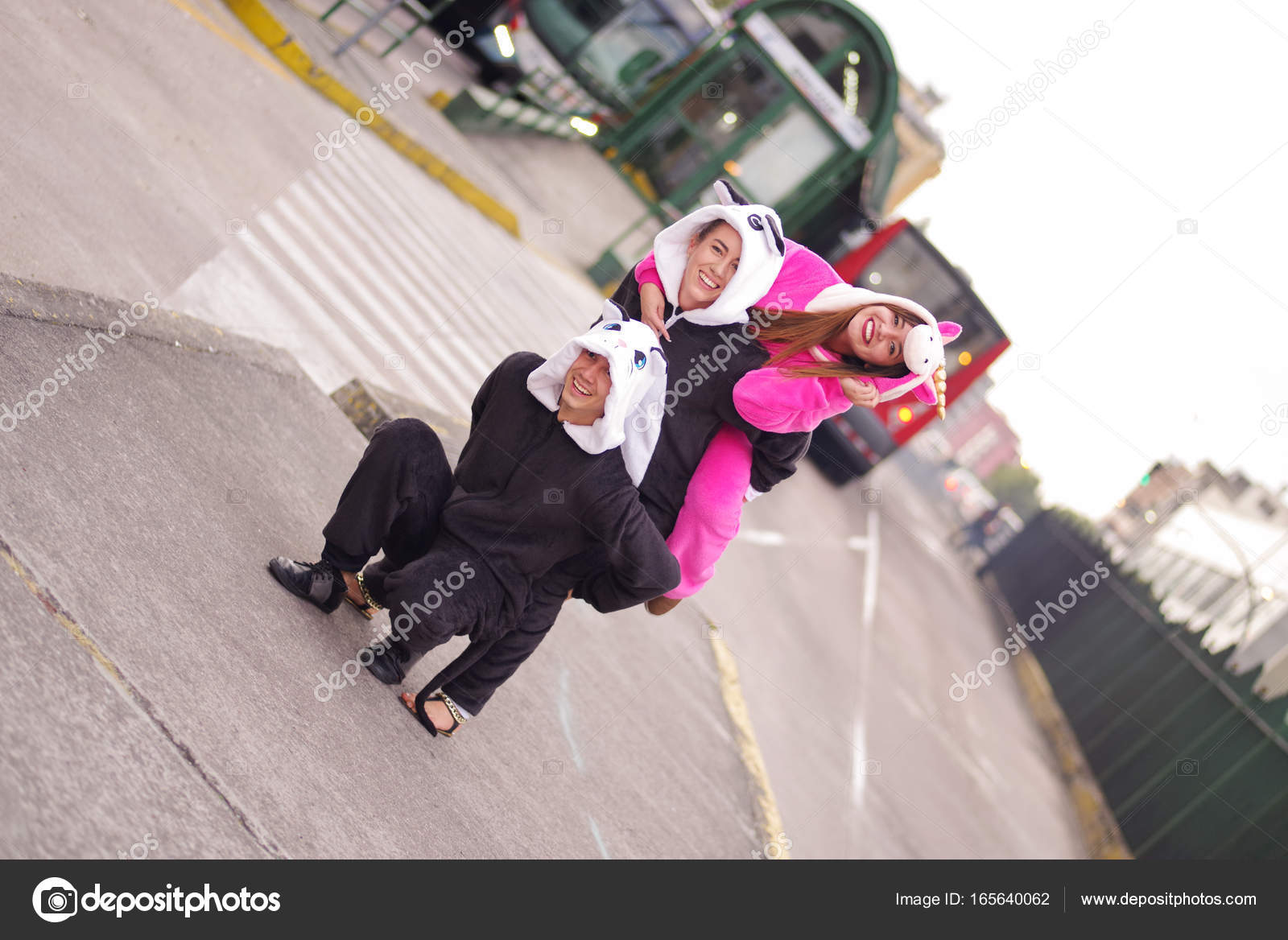 Close Up Of A Happy Group Friends Playing In The Streets And Wearing Different Costumes One Woman Pink Unicorn Costume Other Panda Close Up Of A Happy Group Friends Playing In The Streets And Wearing Different Costumes One Woman Pink Unicorn Costume Other Panda