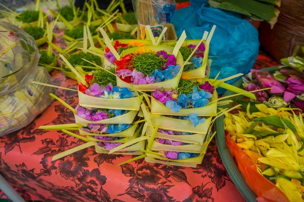 Un marché avec une boîte de feuilles, à l'intérieur d'un arrangement de fleurs sur une table, dans la ville de Denpasar en Indonésie — Photo