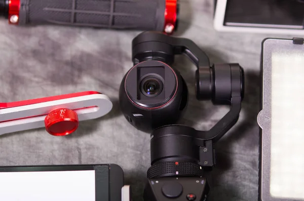 Close up of an Osmo Mobile gimbal, new generation of electronic stabilizer over a gray background — Stock Photo, Image